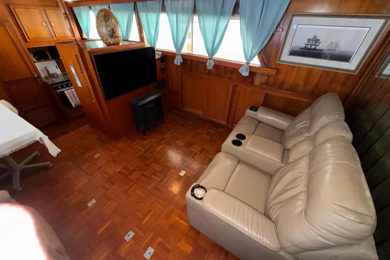 Slide: The Image of Interior of 1988 Jefferson 52 Monticello yacht with leather seating and wood paneling. - 30