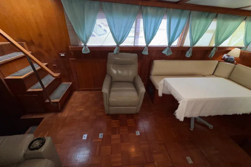Slide: The Image of Interior of 1988 Jefferson 52 Monticello yacht with seating, table, and stairs. - 31