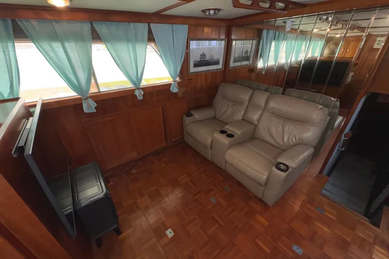 Slide: The Image of 1988 Jefferson 52 Monticello yacht interior with leather recliners and wood paneling. - 33