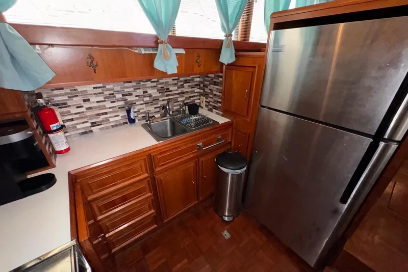 Slide: The Image of Compact kitchen in 1988 Jefferson 52 Monticello with stainless steel fridge and mosaic backsplash. - 35