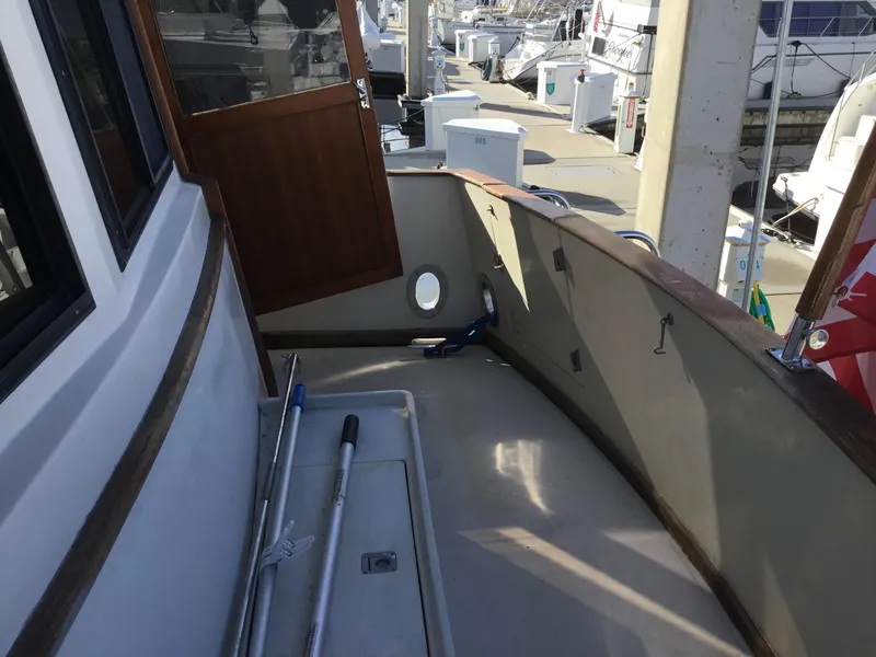 Slide: The Image of Interior of 1988 Jefferson 52 Monticello yacht with wood paneling and cozy furnishings. - 43