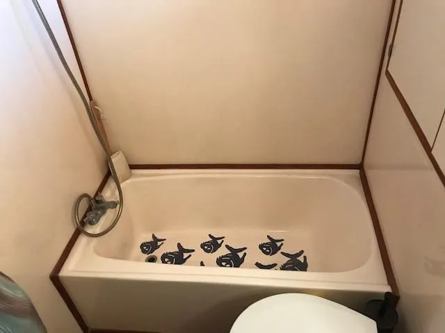 Slide: The Image of Cozy cabin interior of 1988 Jefferson 52 Monticello yacht with twin beds and wood paneling. - 55