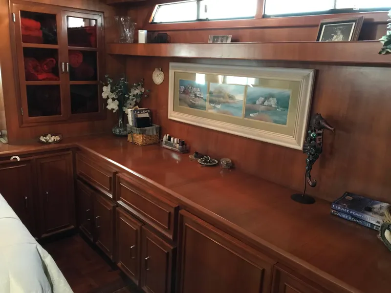 Slide: The Image of 1988 Jefferson 52 Monticello yacht bathroom with wood accents, sink, mirror, and porthole window. - 57