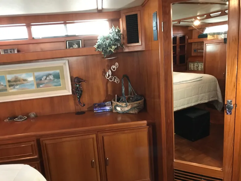 Slide: The Image of Engine room of a 1988 Jefferson 52 Monticello yacht, featuring dual engines and mechanical components. - 58