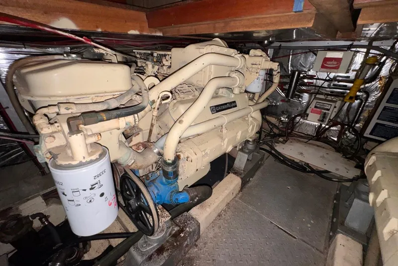Slide: The Image of Engine room of a 1988 Jefferson 52 Monticello yacht, featuring a Caterpillar engine. - 60