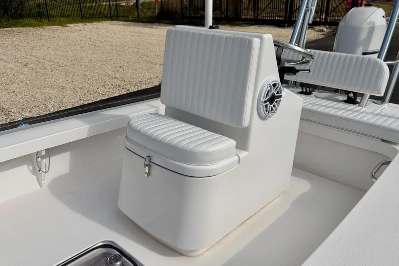 Slide: The Image of 2024 Outlaw Legend 17 boat interior with white cushioned seating and steering console. - 10