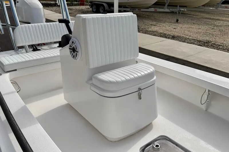 Slide: The Image of 2024 Outlaw Legend 17 boat interior with white cushioned seating and storage compartment. - 11