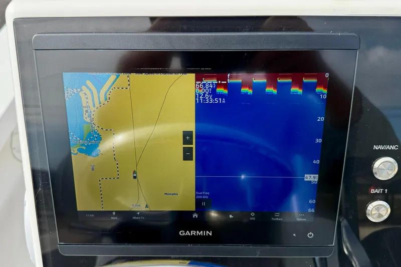 Slide: The Image of Garmin marine GPS display on 2024 Outlaw Legend 17 boat dashboard. - 18