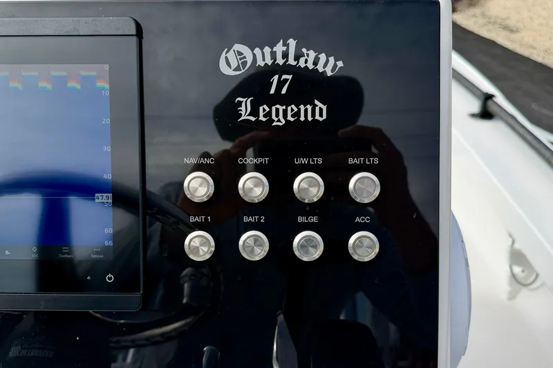 Slide: The Image of Control panel of 2024 Outlaw Legend 17 boat with labeled buttons and display. - 19