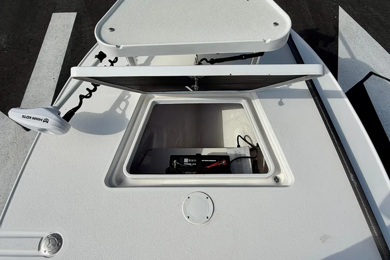 Slide: The Image of 2024 Outlaw Legend 17 boat with open storage compartment and trolling motor. - 25