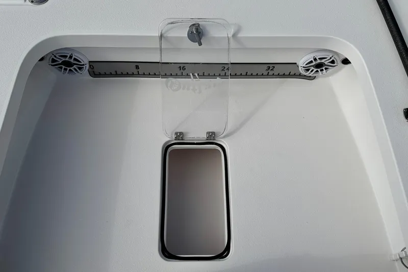 Slide: The Image of 2024 Outlaw Legend 17 boat compartment with measuring scale and hatch. - 26