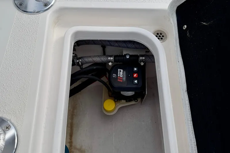 Slide: The Image of 2024 Outlaw Legend 17 boat compartment with Pro Series equipment and wiring. - 29