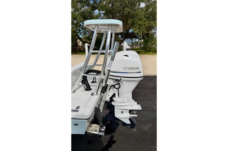 Slide: The Image of 2024 Outlaw Legend 17 boat with Yamaha outboard motor, parked outdoors. - 30