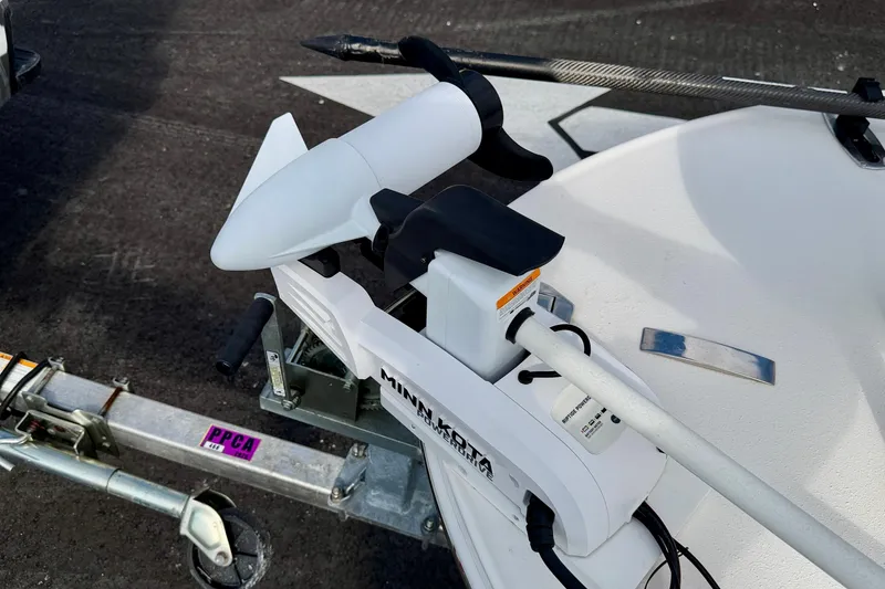 Slide: The Image of 2024 Outlaw Legend 17 boat with Minn Kota trolling motor on trailer. - 38