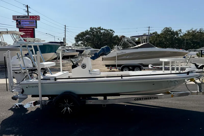 Slide: The Image of 2024 Outlaw Legend 17 boat on trailer at dealership, side view. - 4