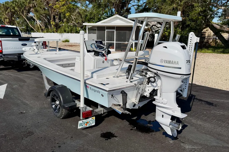 Slide: The Image of 2024 Outlaw Legend 17 boat with Yamaha engine on trailer, parked outdoors. - 5