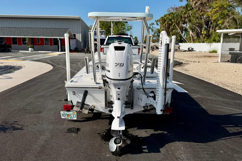 Slide: The Image of 2024 Outlaw Legend 17 boat with Yamaha engine, parked on a sunny driveway. - 6