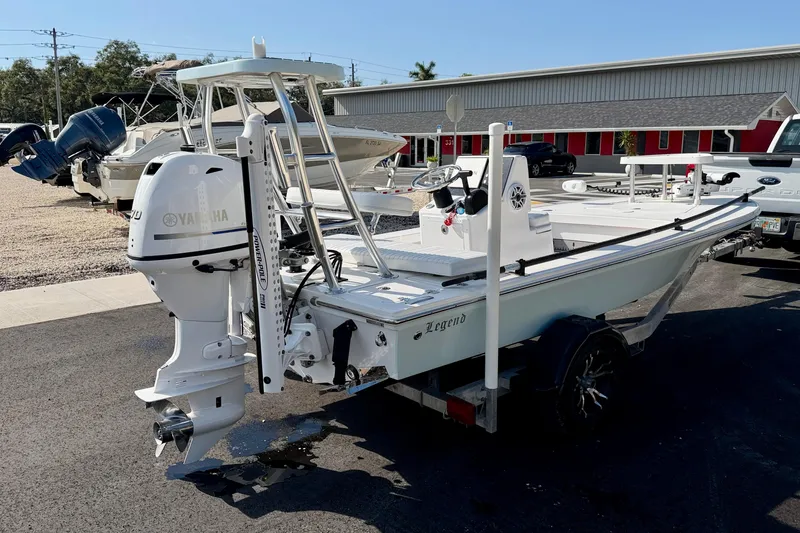 Slide: The Image of 2024 Outlaw Legend 17 boat with Yamaha outboard motor on trailer in parking lot. - 7
