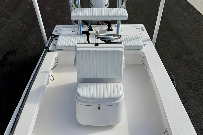 Slide: The Image of 2024 Outlaw Legend 17 boat interior with white seating and steering wheel. - 9