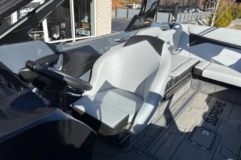 Slide: The Image of 2023 Supreme ZS232 boat interior with modern steering and seating design. - 10