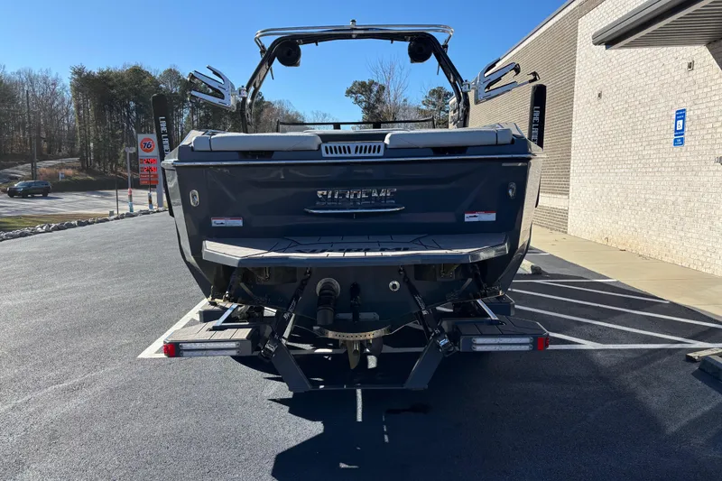 Slide: The Image of 2023 Supreme ZS232 boat rear view in parking lot, showcasing sleek design and trailer setup. - 5