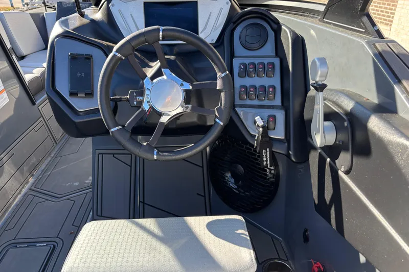 Slide: The Image of 2023 Supreme ZS232 boat dashboard with steering wheel and control panel. - 9