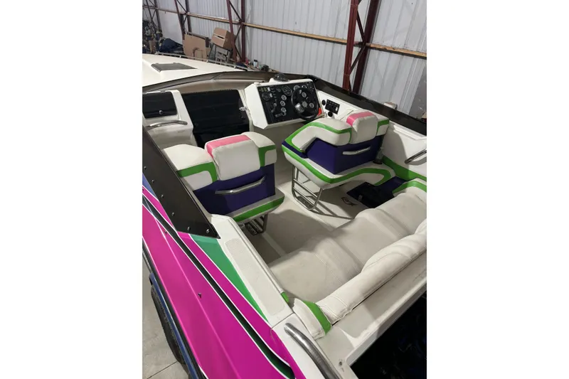 Slide: The Image of 1992 Fountain 27 Fever boat interior with colorful seating and dashboard. - 10