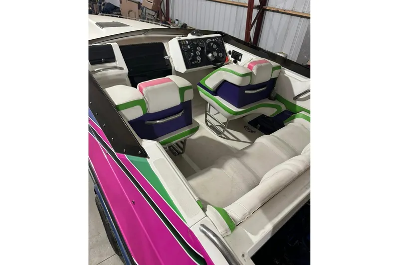 Slide: The Image of 1992 Fountain 27 Fever boat interior with vibrant pink, green, and white seating. - 3