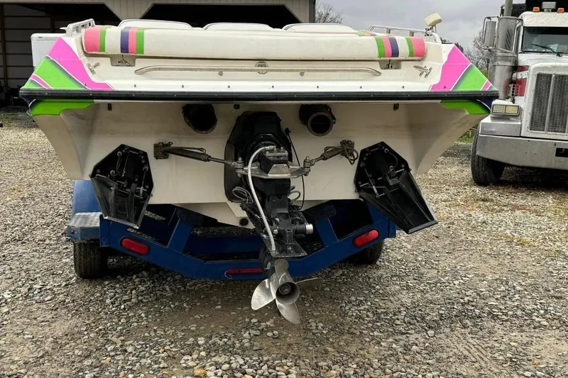 Slide: The Image of 1992 Fountain 27 Fever boat on trailer, vibrant colors, parked on gravel. - 4