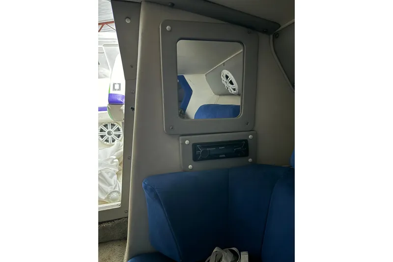 Slide: The Image of Interior of 1992 Fountain 27 Fever boat with blue seating and audio system. - 6