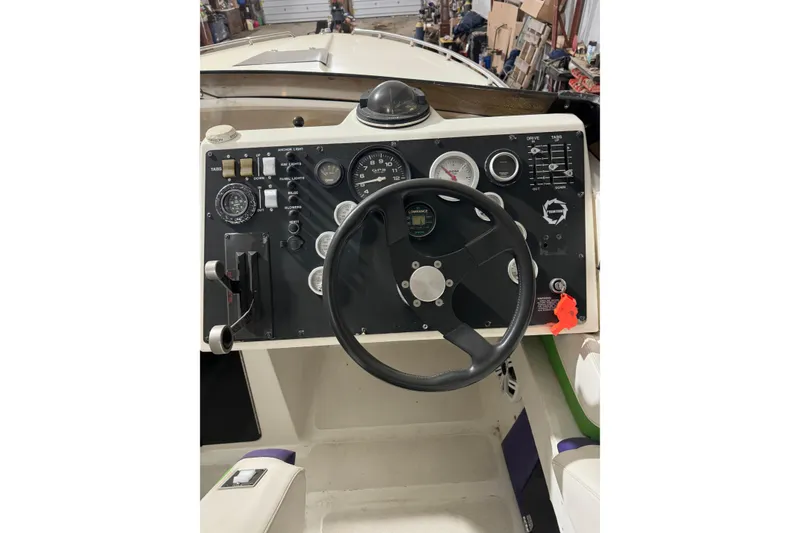 Slide: The Image of 1992 Fountain 27 Fever boat dashboard with steering wheel and control gauges. - 9
