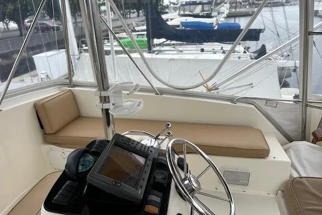 Slide: The Image of 1988 Ocean 44' Super Sport yacht helm with navigation equipment and marina view. - 11