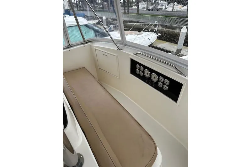 Slide: The Image of 1988 Ocean 44' Super Sport boat interior with control panel and seating. - 12