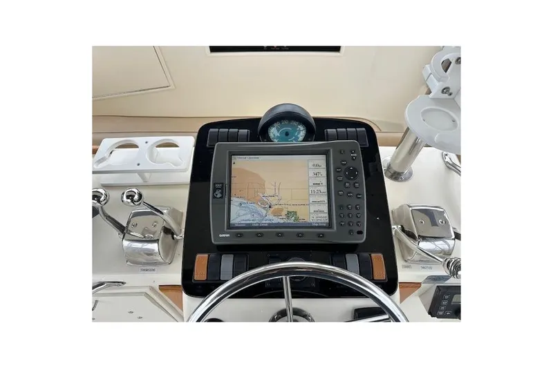 Slide: The Image of 1988 Ocean 44' Super Sport yacht helm with navigation system and controls. - 19