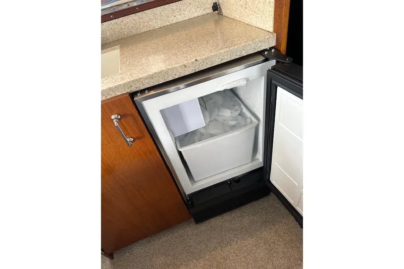 Slide: The Image of Open mini fridge with ice compartment on 1988 Ocean 44' Super Sport yacht. - 22