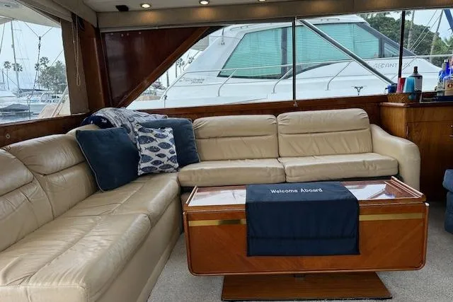 Slide: The Image of Luxurious 1988 Ocean 44' Super Sport yacht interior with beige leather seating and nautical decor. - 24