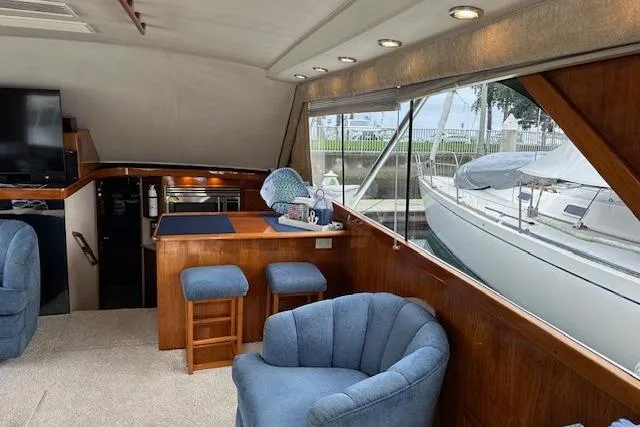 Slide: The Image of Interior of 1988 Ocean 44' Super Sport yacht with cozy seating and dockside view. - 27