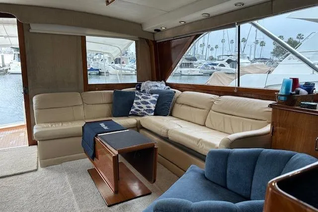 Slide: The Image of Luxurious interior of 1988 Ocean 44' Super Sport yacht with plush seating and marina view. - 28