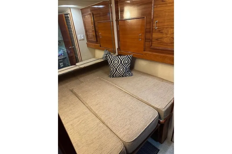 Slide: The Image of Interior cabin of 1988 Ocean 44' Super Sport yacht with cushioned seating and wooden cabinets. - 34