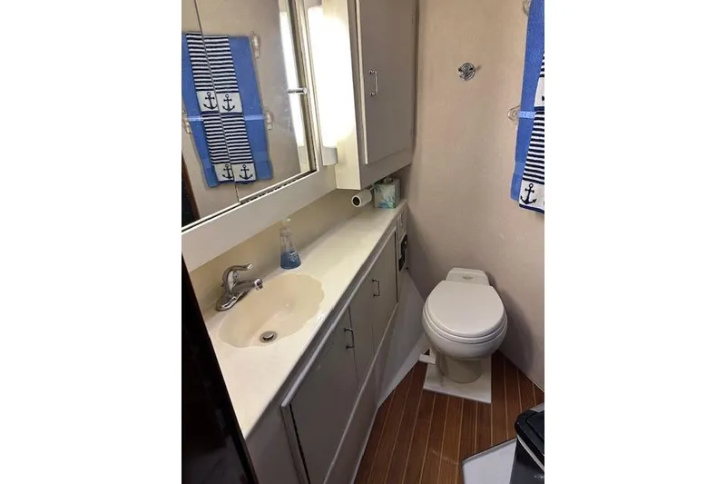 Slide: The Image of Bathroom interior of 1988 Ocean 44' Super Sport yacht with nautical decor. - 35