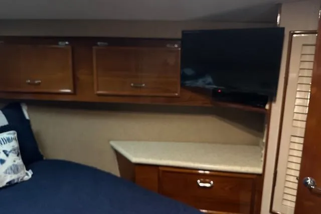 Slide: The Image of Interior of 1988 Ocean 44' Super Sport yacht with wood cabinets and mounted TV. - 39