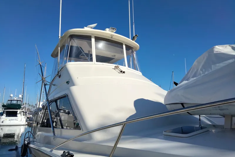 Slide: The Image of 1988 Ocean 44' Super Sport yacht docked under clear blue sky. - 4