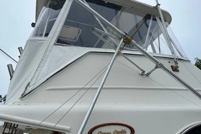 Slide: The Image of 1988 Ocean 44' Super Sport yacht with white exterior and fishing equipment. - 40