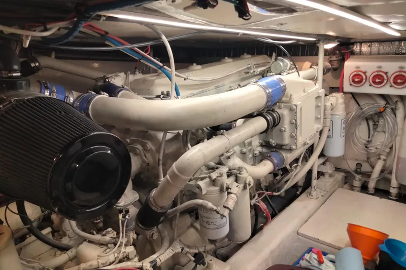 Slide: The Image of Engine room of 1988 Ocean 44' Super Sport yacht, showcasing complex machinery and components. - 43