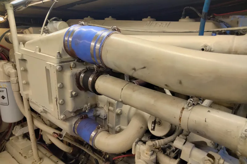 Slide: The Image of Engine compartment of a 1988 Ocean 44' Super Sport yacht, featuring pipes and components. - 44