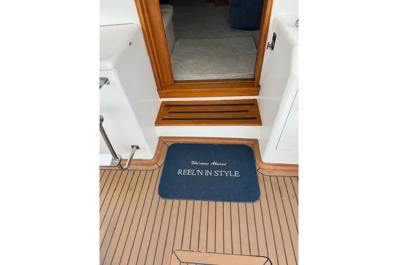 Slide: The Image of Welcome mat on 1988 Ocean 44' Super Sport yacht, wooden deck, cabin entrance. - 9