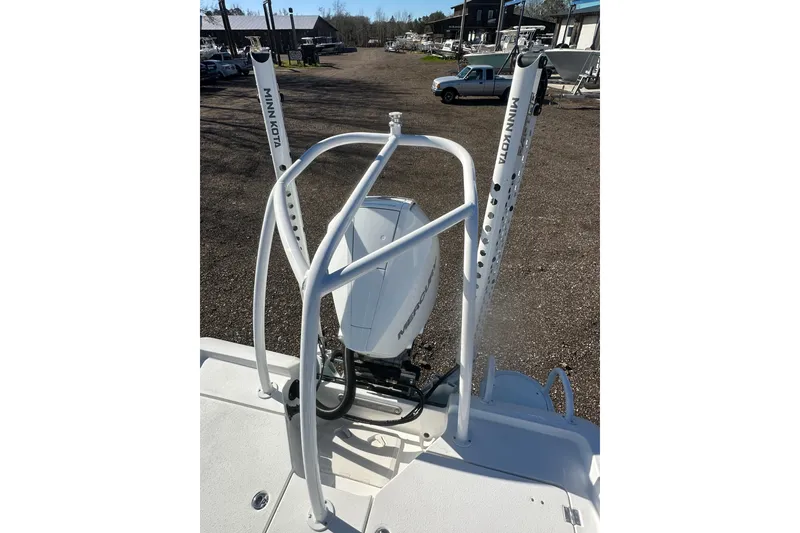 Slide: The Image of 2026 Action Craft 24 Bay boat with Minn Kota accessories in a marina setting. - 14