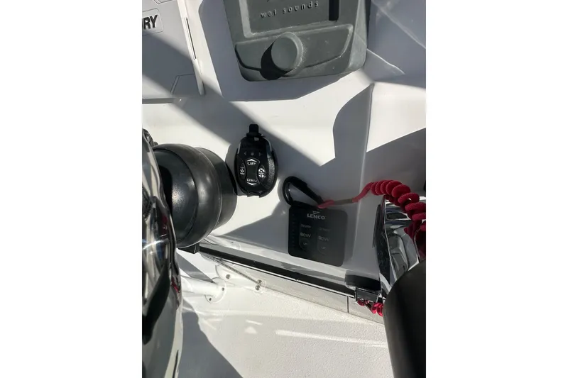 Slide: The Image of Control panel of 2026 Action Craft 24 Bay boat with Lenco trim tab switches. - 19