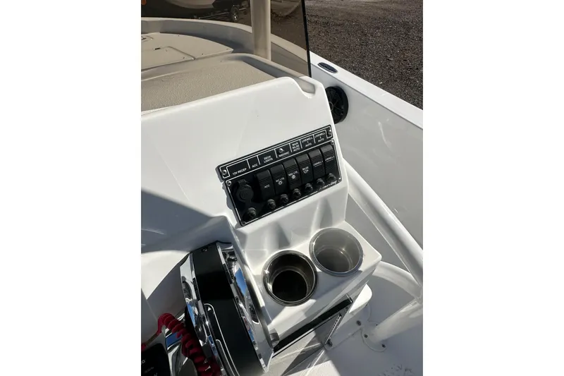 Slide: The Image of Control panel of 2026 Action Craft 24 Bay boat with cup holders and switches. - 20