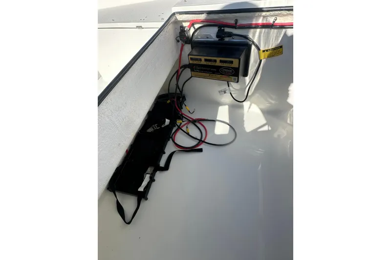 Slide: The Image of Interior view of 2026 Action Craft 24 Bay boat showing battery compartment and wiring. - 26